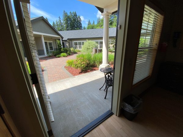 Photo of a hospice care center room door opening to outdoor garden